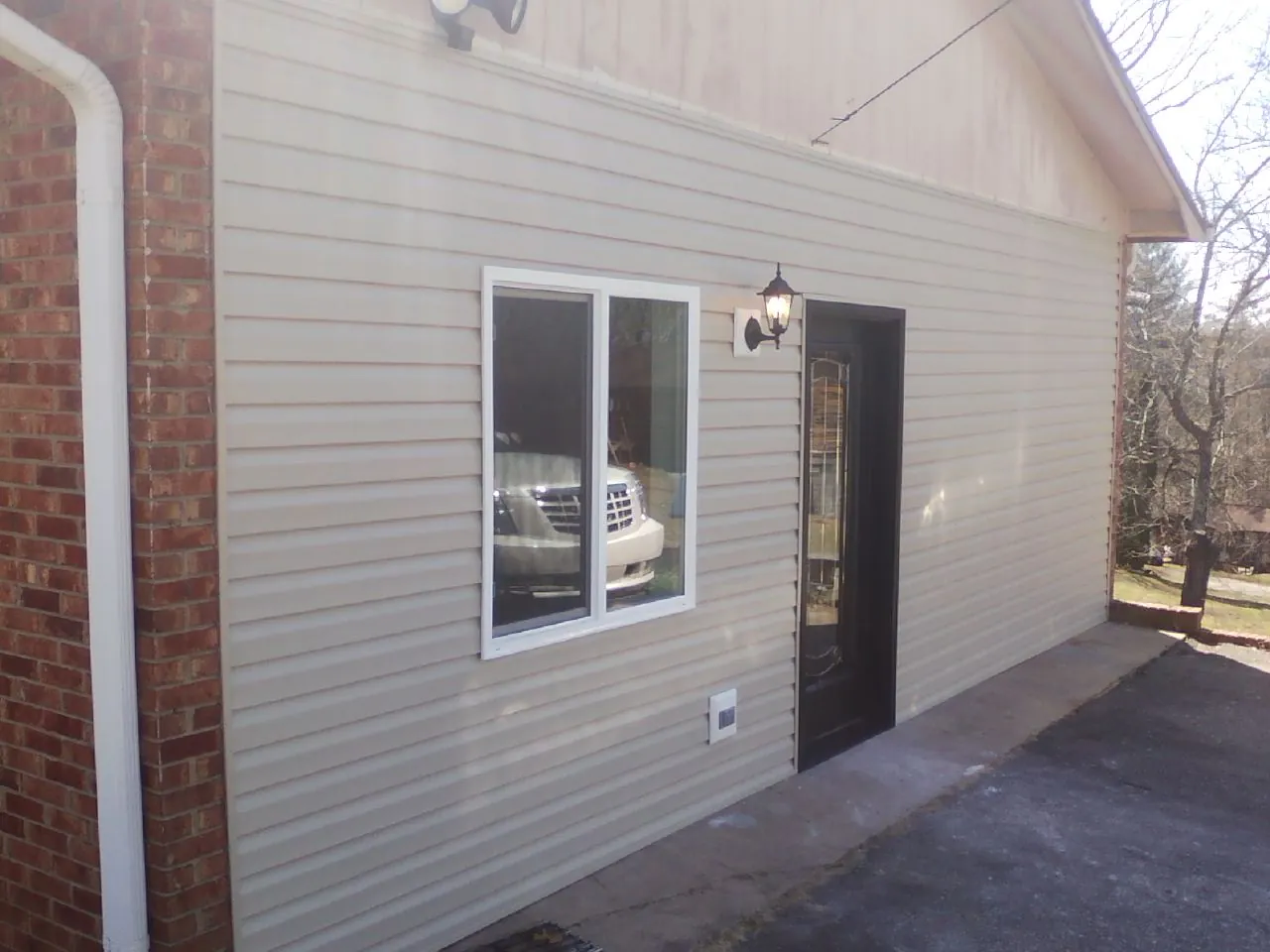New vinyl siding and entry door on a room addition in Leesburg